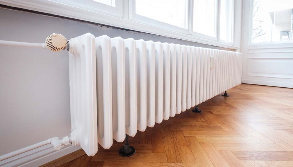radiator in apartment with hardwood floor