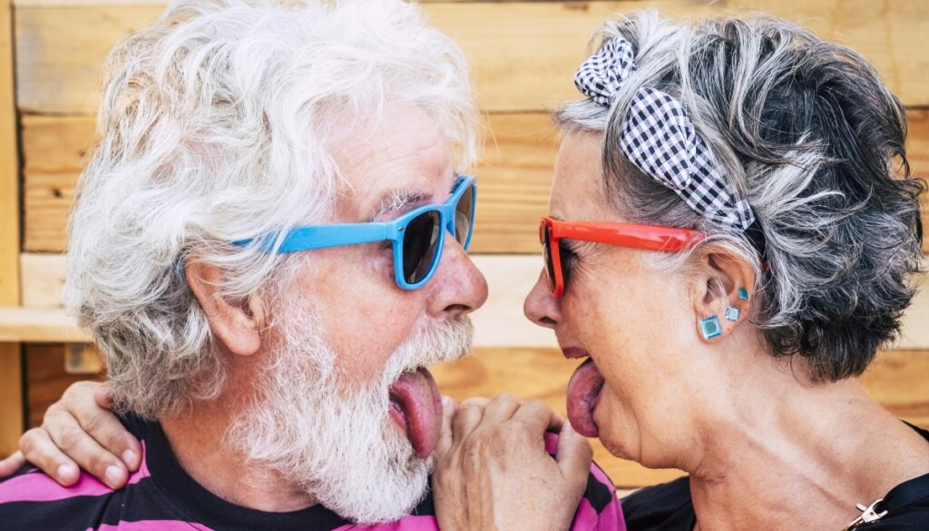 Older couple wearing sunglasses and making funny faces