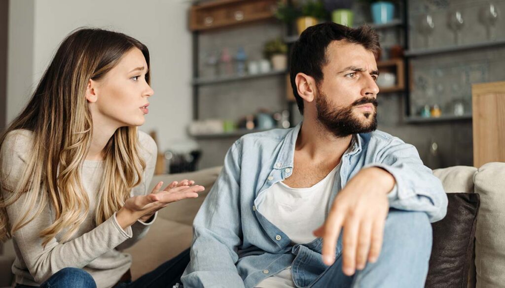 woman explaining something tough to her spouse as he looks away