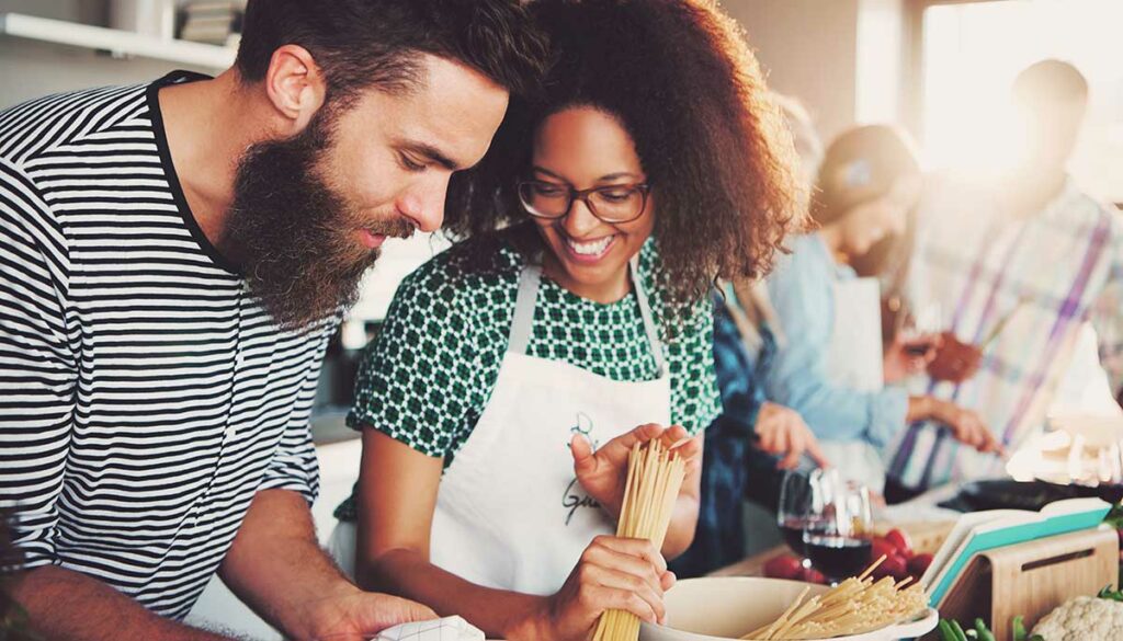 a couple making dinner together, cooking class concept