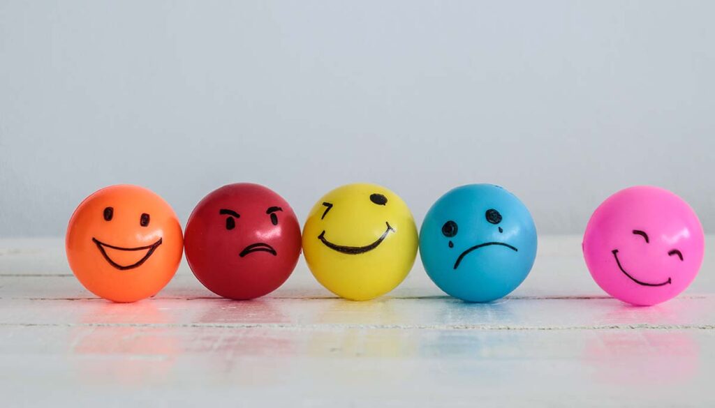 five marble sized, colorful balls representing emotions ranging from joy to anger 