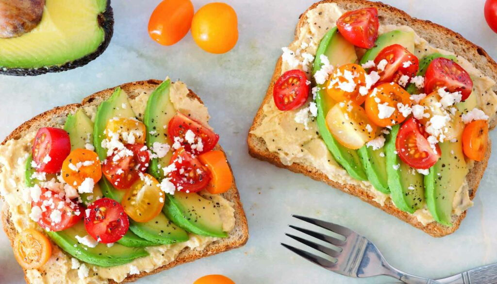 hummus toast with tomato and avocado slices