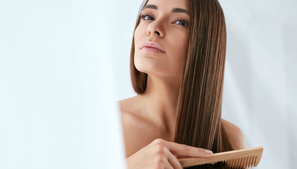 woman brushing her long healthy hair