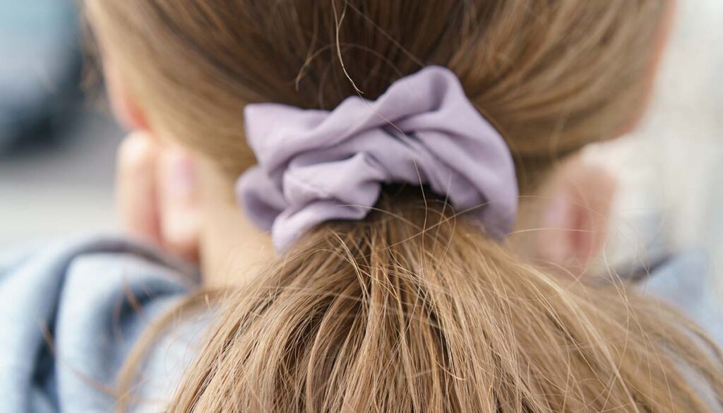 close up of low pony tail in scrunchy 