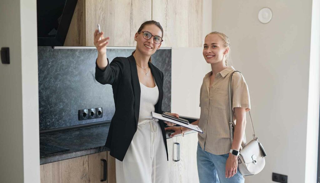 real estate agent showing a woman an apartment