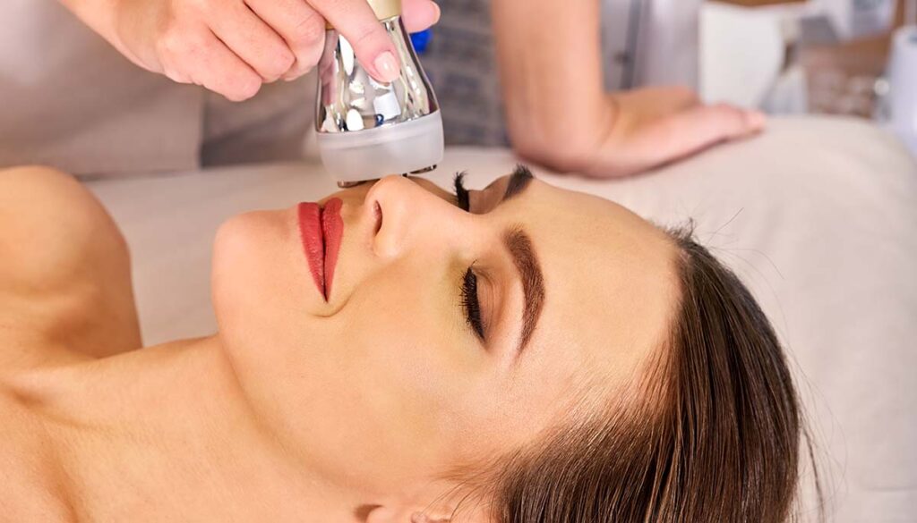 woman receiving ultrasound therapy for skin tightening on her face