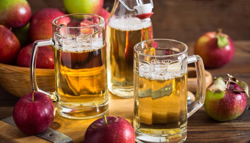 hard apple cider surrounded by apples