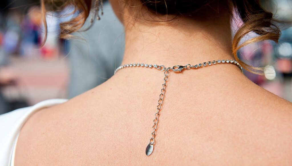 clasp chain on back of young woman's neck