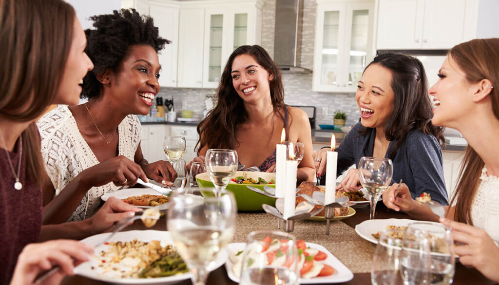 Group Of Female Friends Enjoying Dinner Party At Home