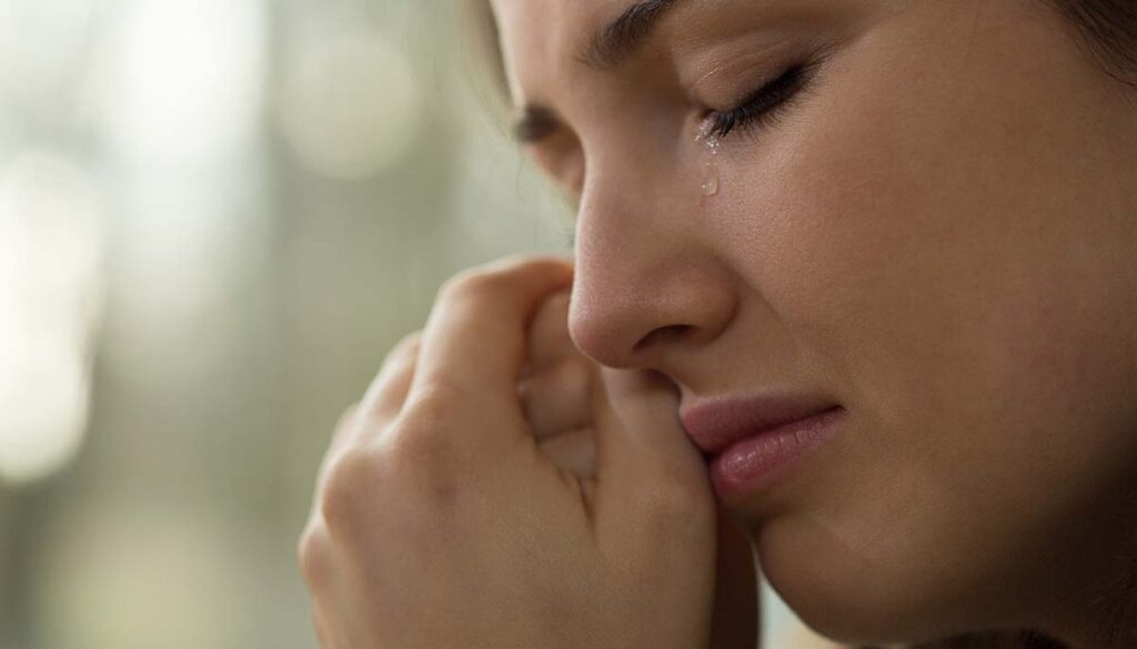 Close-up of woman with problems crying