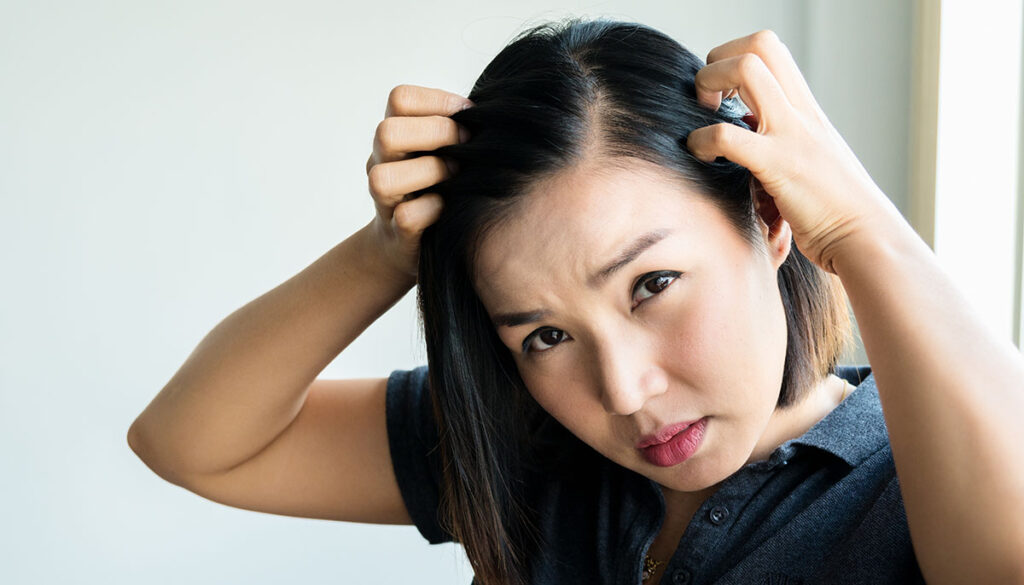 Sad asian girl looking at her damaged hair, Postpartum hair loss condition