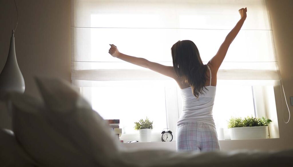 woman stretching in the morning after a good night's sleep