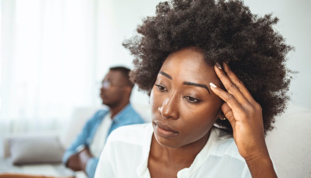 frustrated woman with man in the background