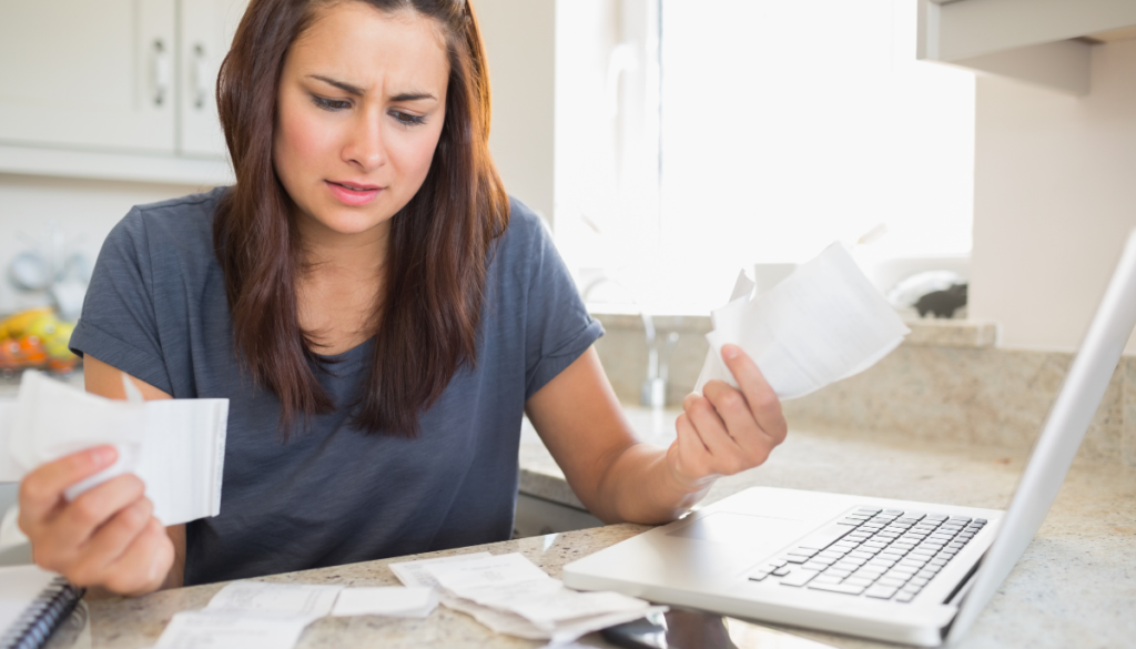 Stressed woman looking at receipts