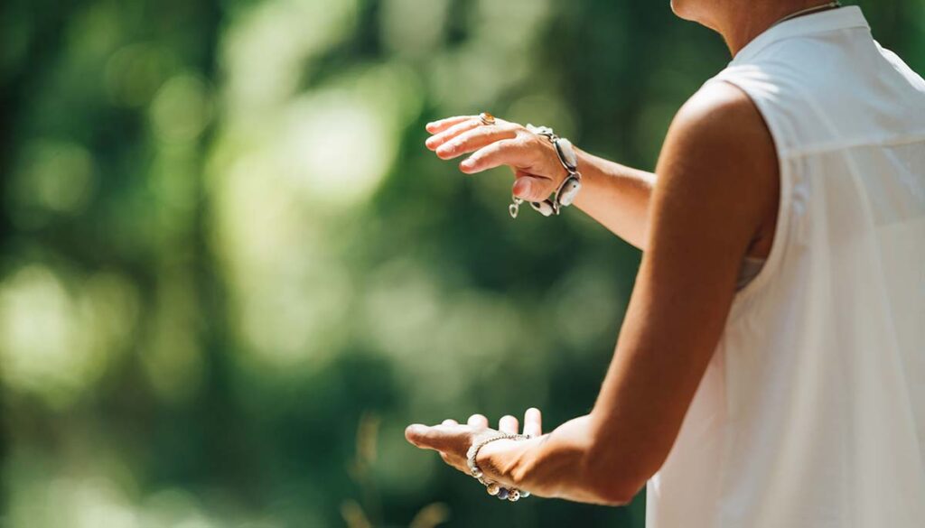 woman exercising Tai Chi in nature, Close up on hands