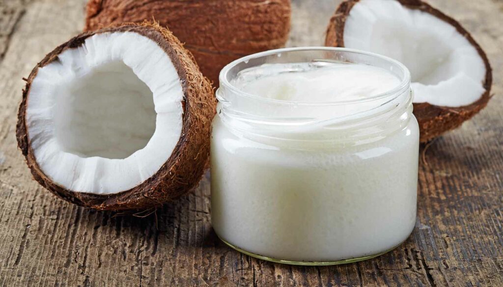 jar of coconut oil with coconuts