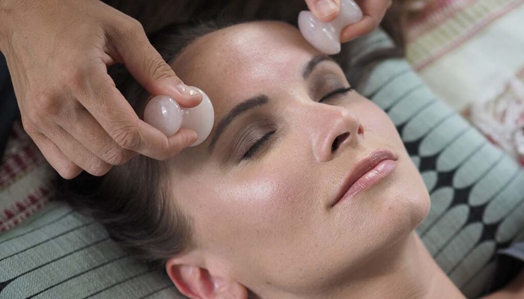 Facial massage with natural healing stones - rose quartz