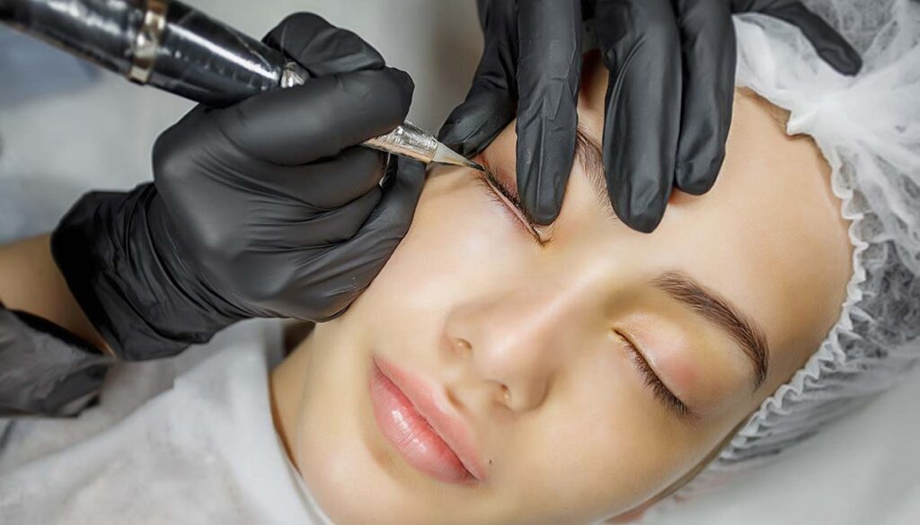 Permanent make up eyeliner procedure, applying on a woman