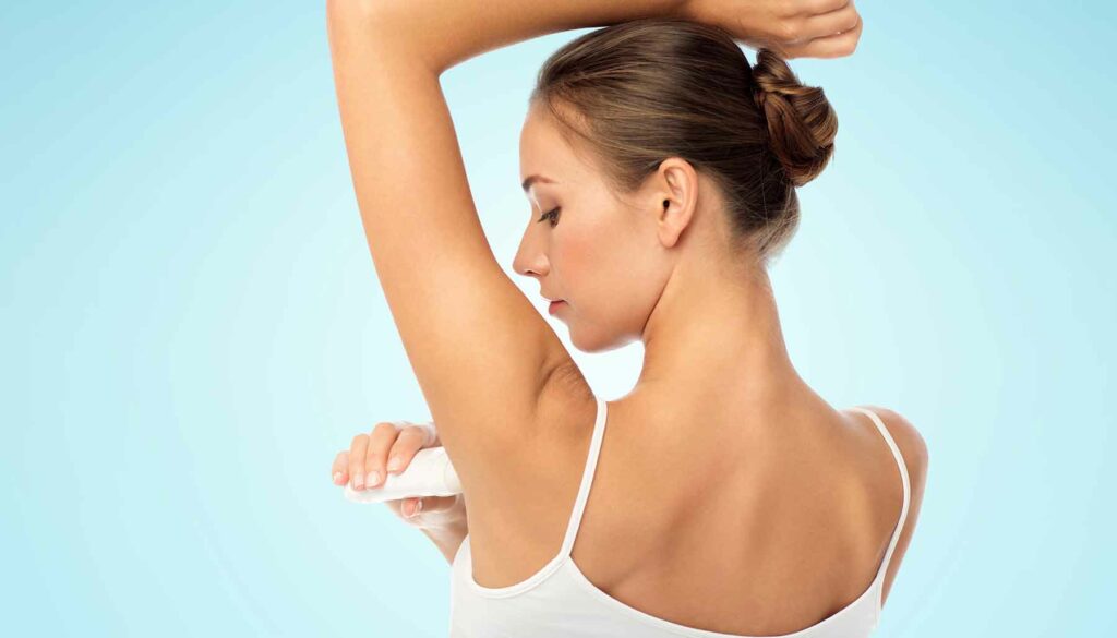woman applying deodorant