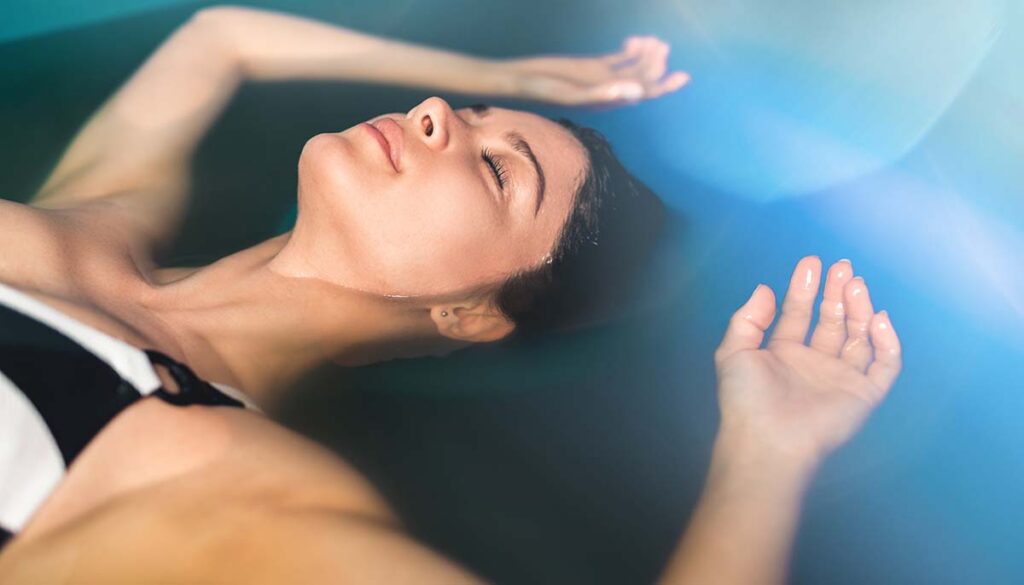 oman floating in tank filled with dense salt water used in meditation, therapy, 