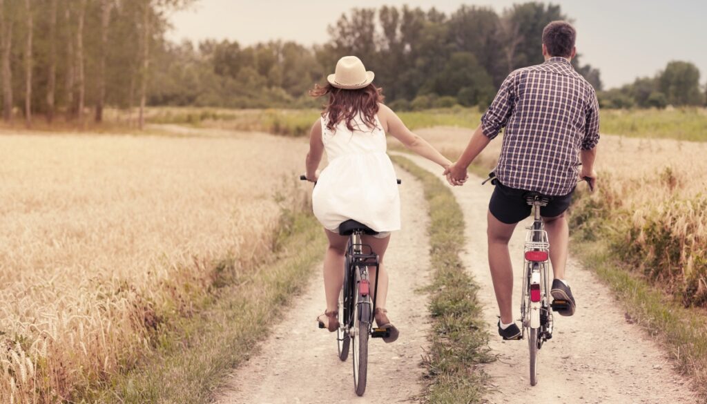 A man and woman riding bikes