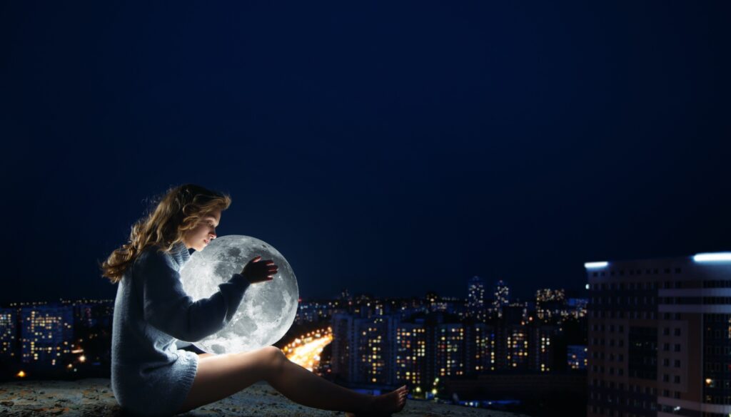 Woman holds a full moon
