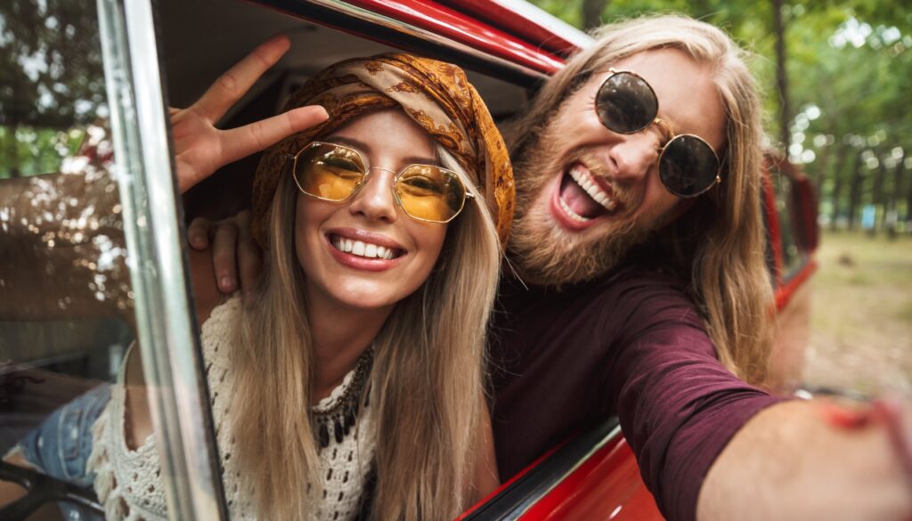 Hippies wearing sunglasses in a van