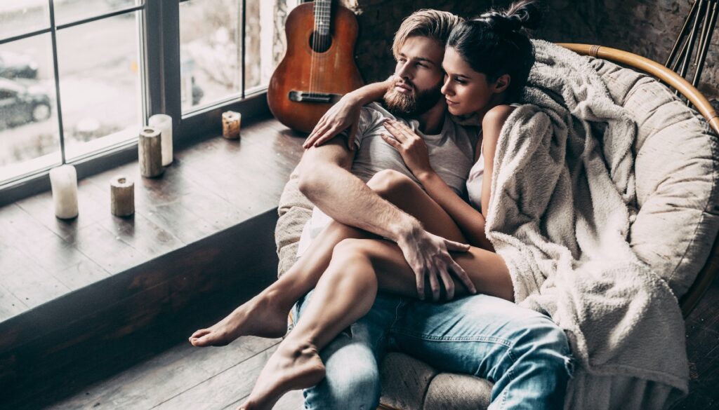 a couple is cuddled up in a chair