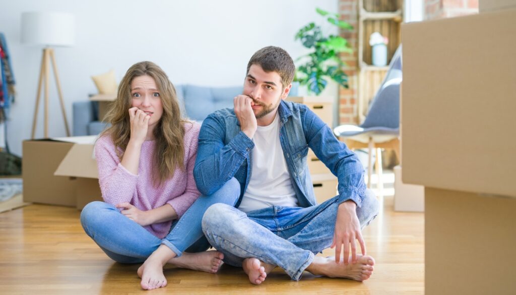 an anxious couple biting their nails