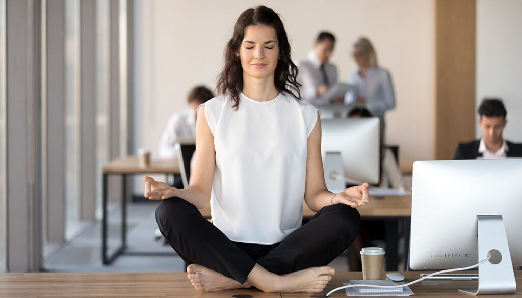 Woman meditating on her desk