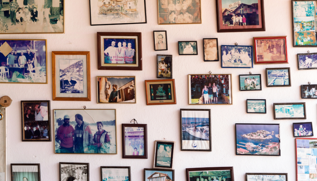 A wall of family photographs in many different frames