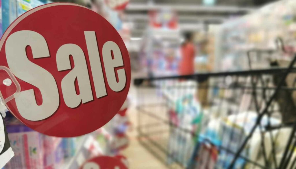 sale sign on grocery store shelf