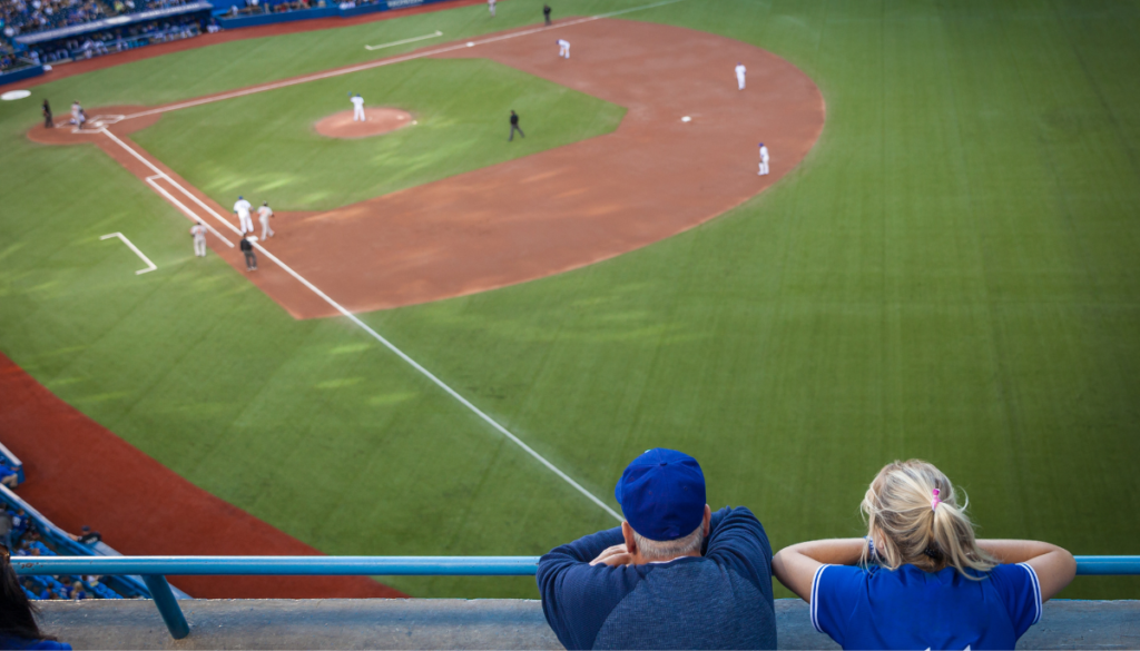 Couple watching baseball game together at the field