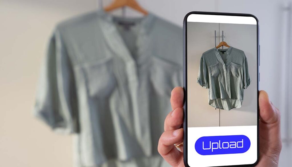View of a person taking a photo of a blouse to upload in a second hand clothes app