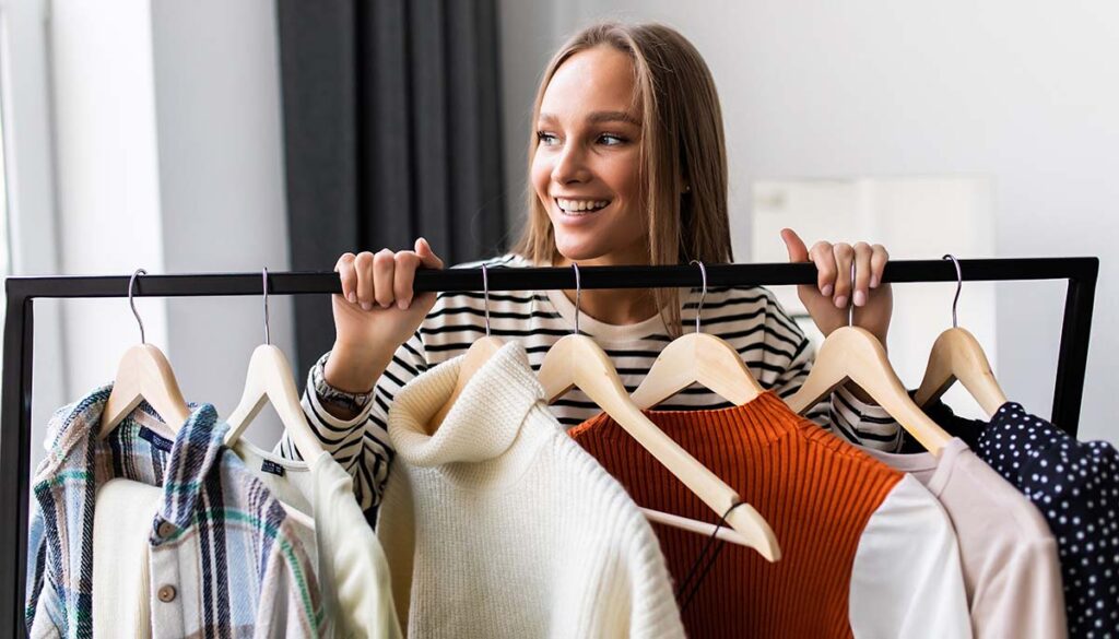 woman standing over clothing rack