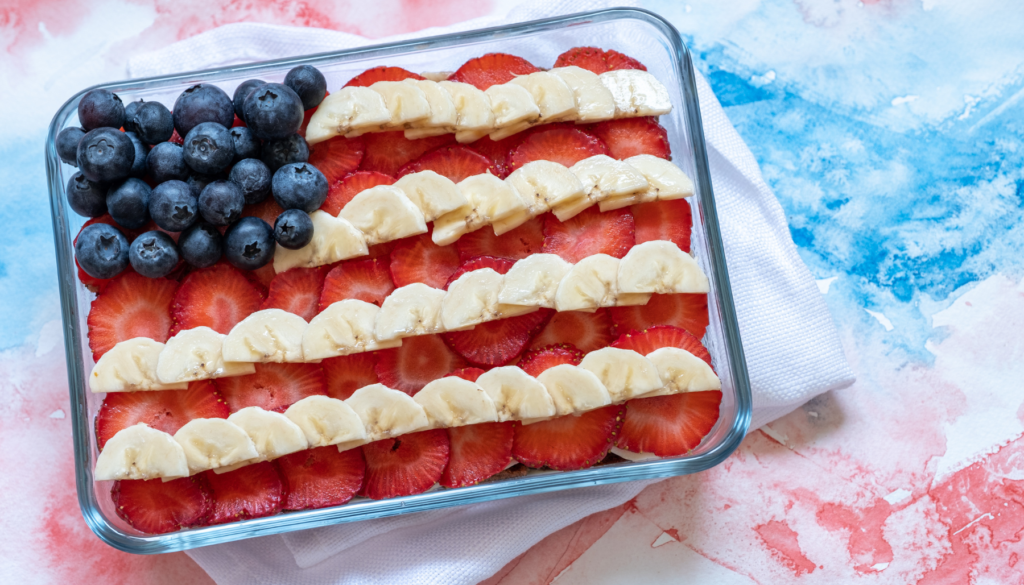 American flag cake with blueberries, strawberries, and bananas