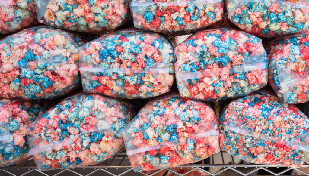 Clear plastic bags of popcorn dyed red, white, and blue