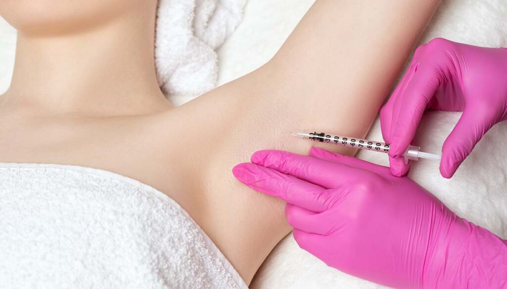 doctor makes injections of botulinum toxin in the underarm area against hyperhidrosis