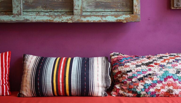 Cozy colorful pattern throw cushion on the red seat
