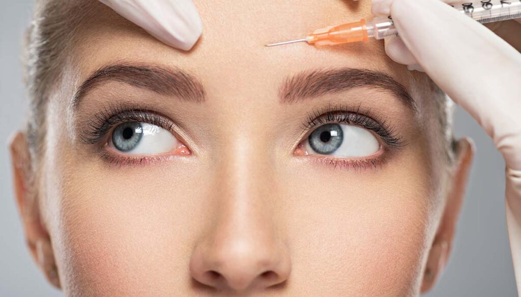 woman getting cosmetic injection of botox in forehead