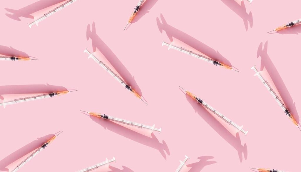 syringes on pink background