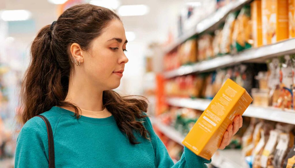 woman looking at food in grocery store