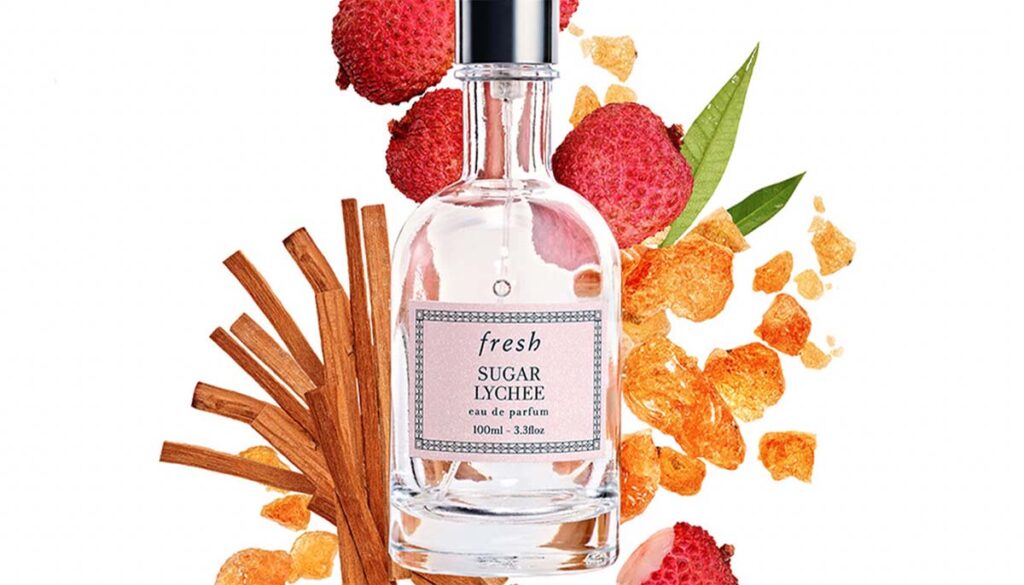 Fresh Lychee perfume on lychee and sugar covered background 
