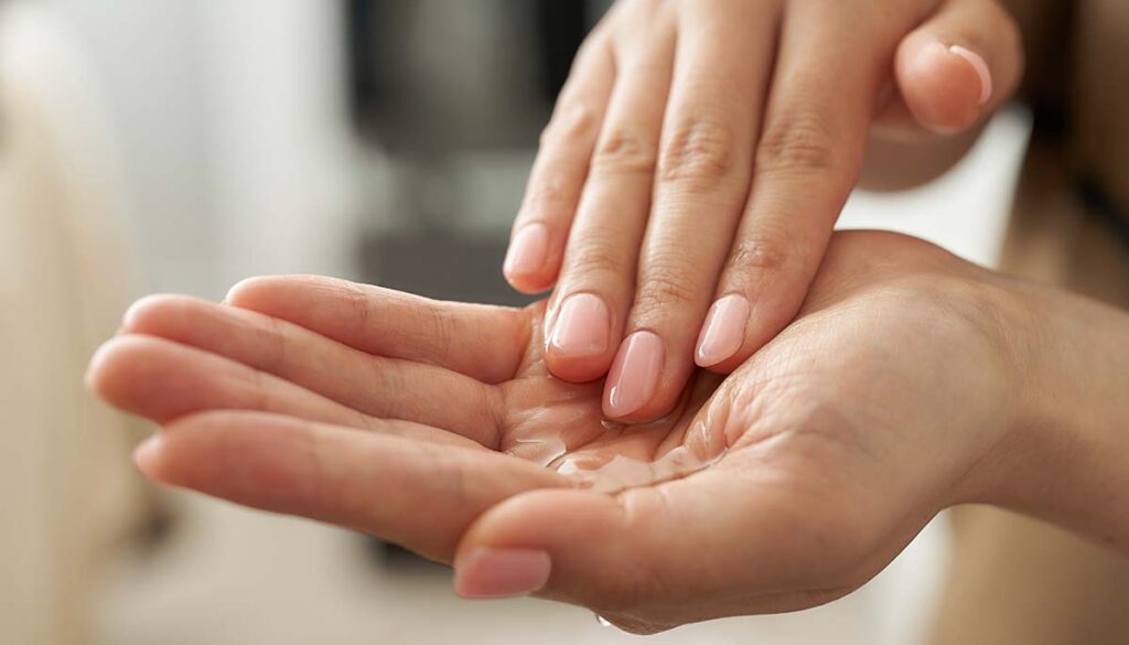 person massaging oil into their hands