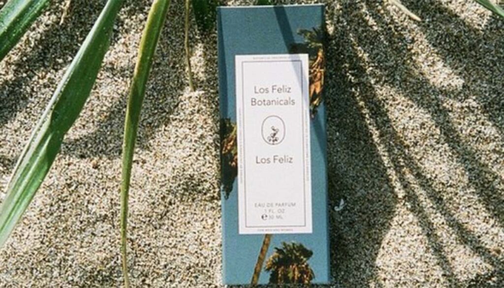 Los Feliz perfume on sand with palm 