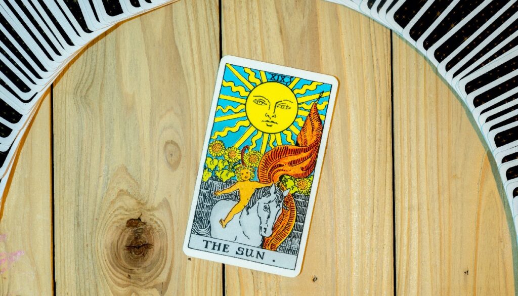 the sun card under a deck of cards