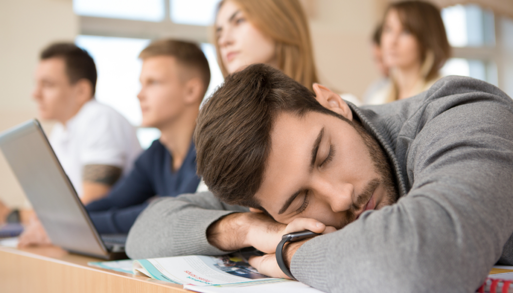Young man asleep in a college class