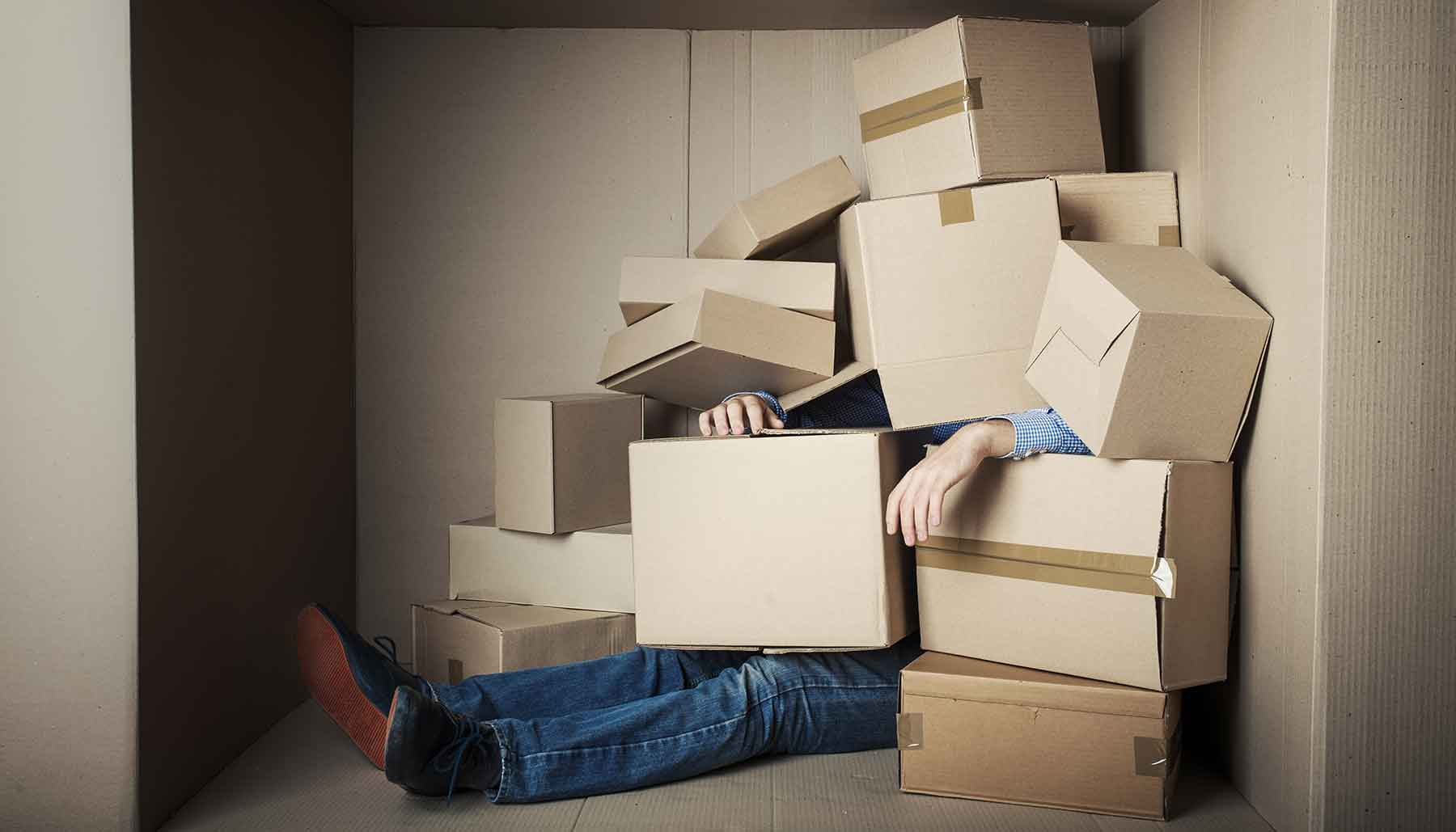 man covered in boxes