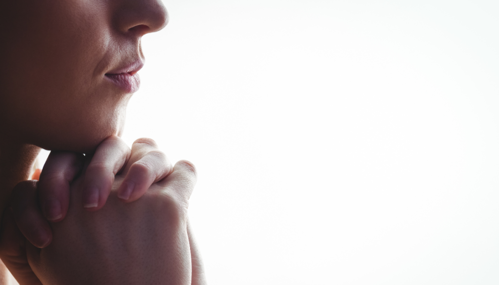 Close up side profile of person resting chin on hands