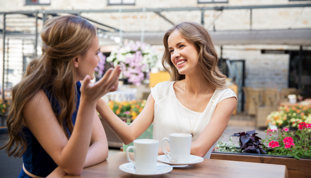 Two young woman talking over coffee
